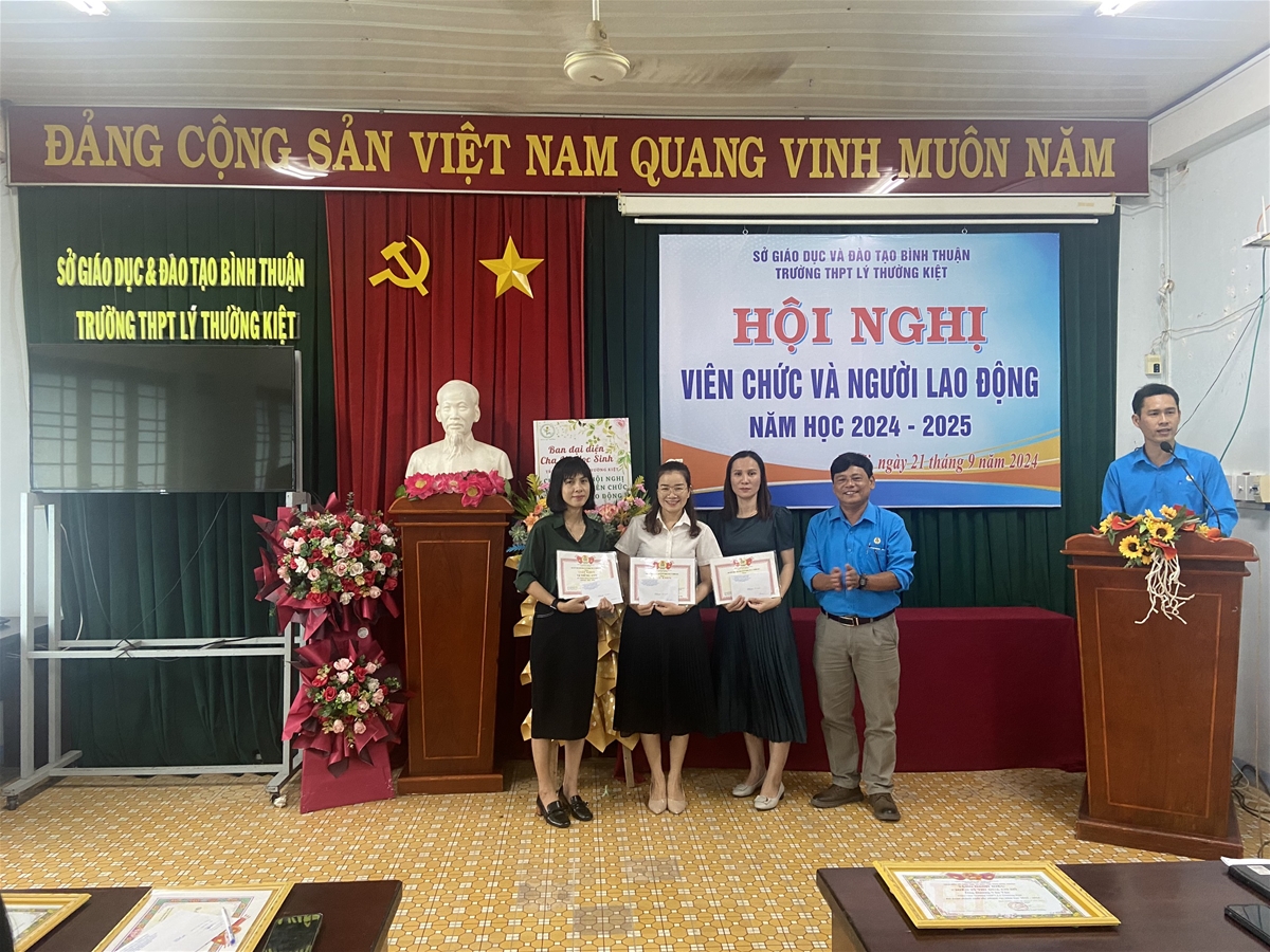 Description: A group of people standing in front of a podiumDescription automatically generated